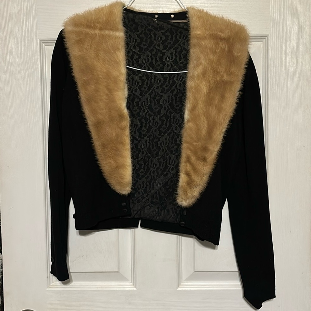 Faux fur lined vintage sweater. It’s an antique in decent condition.